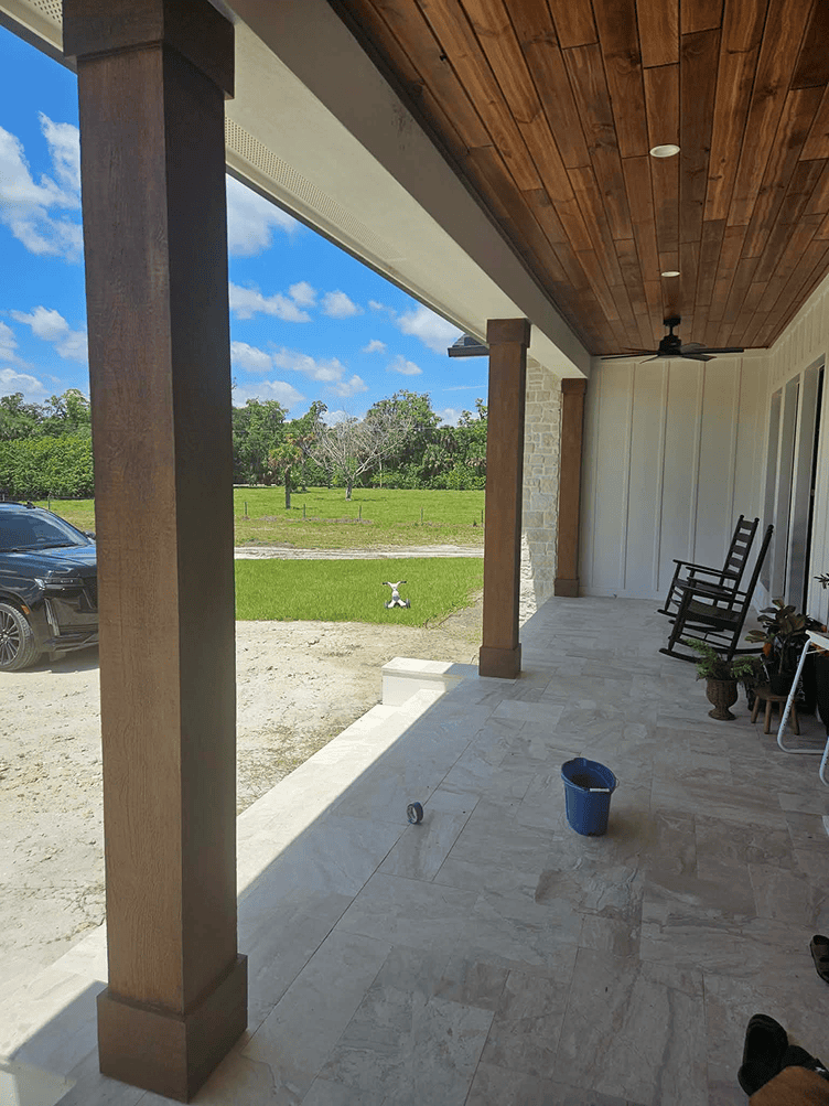 Front porch with wooden ceiling and rocking chairs