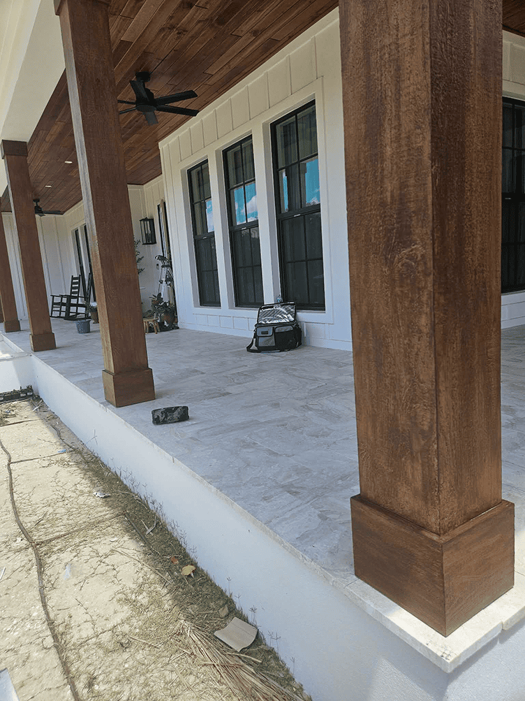 Covered porch with wooden columns and tiled floor