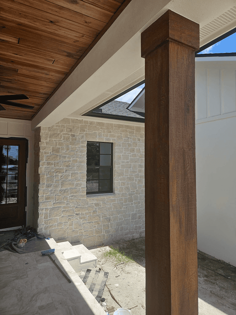Wooden porch column and stone exterior wall