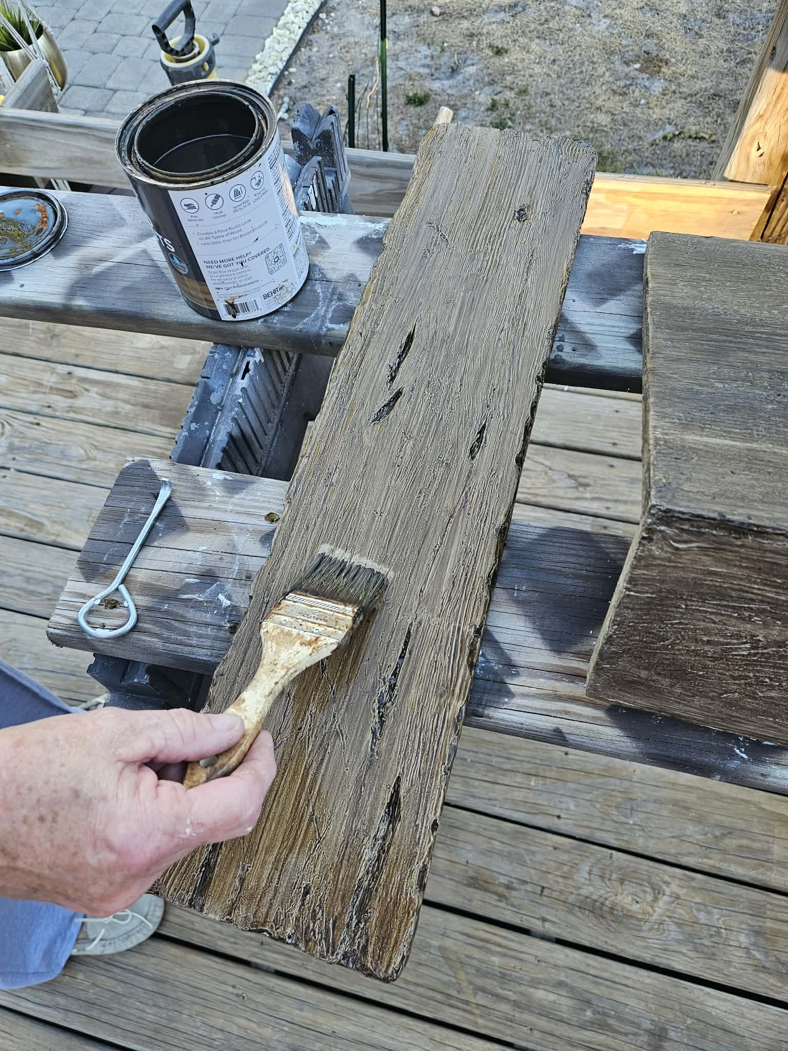 Hand painting weathered wooden plank with brush