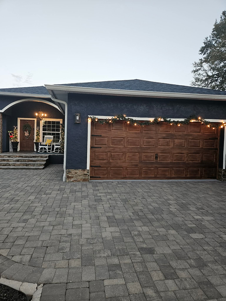 House with wooden garage door and string lights
