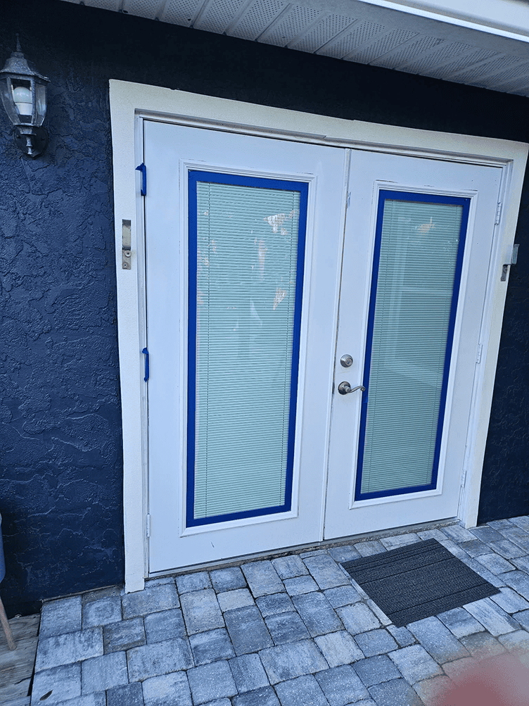 White double French doors with blue trim