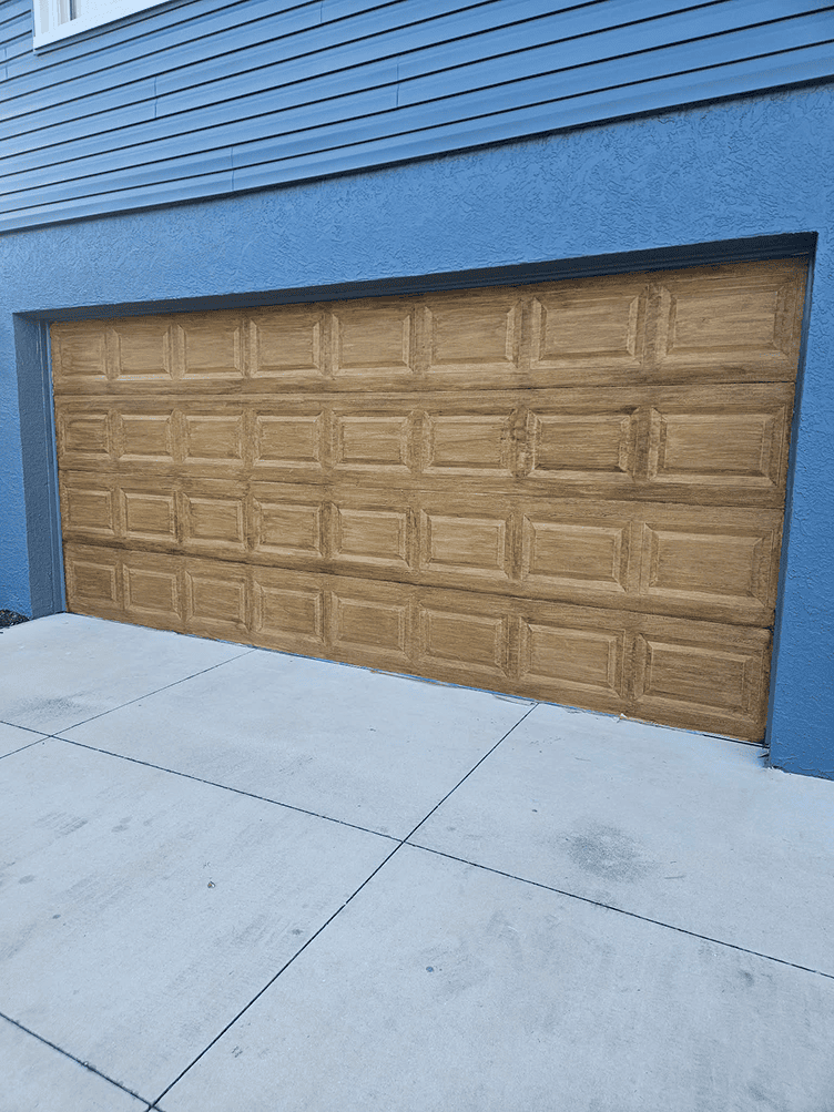 Wooden garage door on blue house