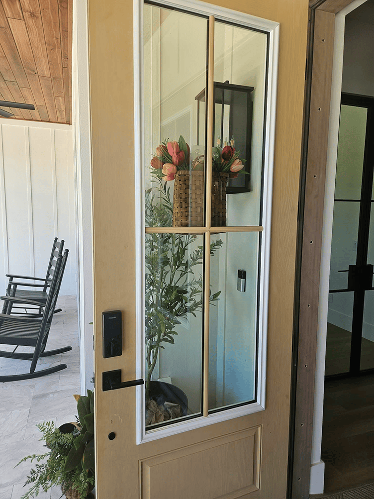 Open front door with tulips in vase