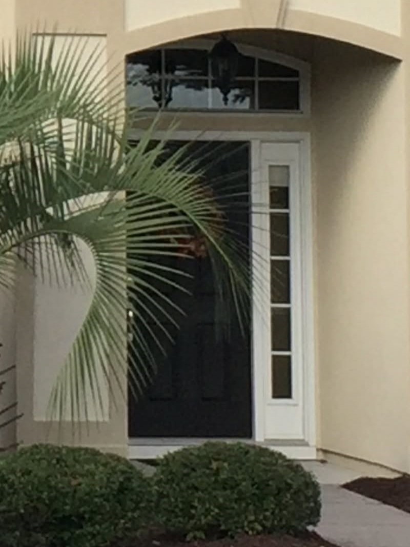 Front entrance with black door and sidelight